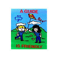 unbound fun badge with an embroidered picture of two guides fling a red and yellow kite together in the outdoors