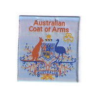 unbound badge with the Australian coat of arms and a gold trefoil with orange writing on a light blue background
