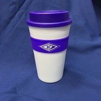 white thermal travelog with purple lid and a purple band around the centre with the BP emblem