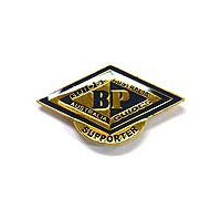 a diamond shape metal badge in gold and maroon with the BP emblem on the front