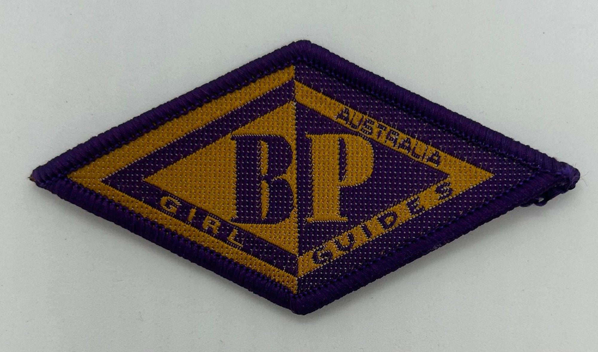 a diamond shaped badge with the BP logo on it