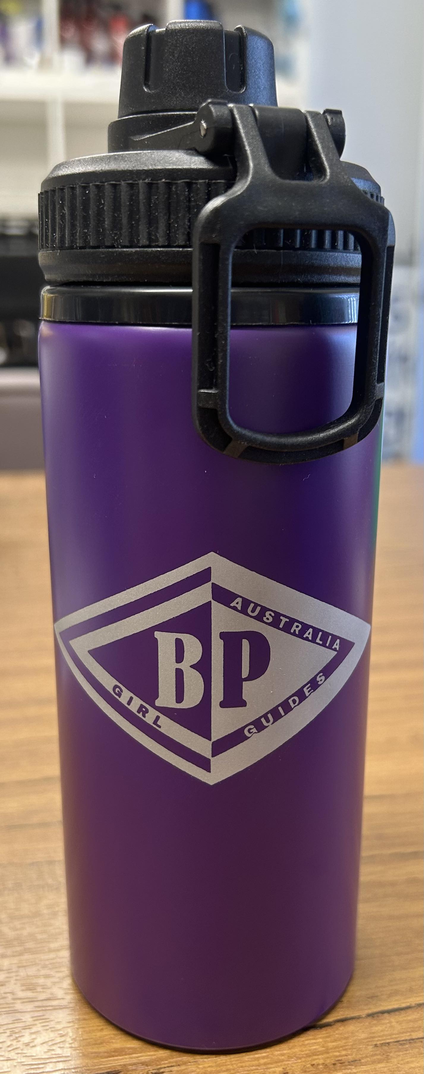 a purple aluminium drink bottle with the BP emblem on the front