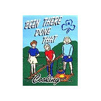 unbound cloth badge that has three girls cooking on a campfire in the outdoors
