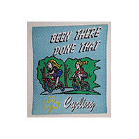 unbound cloth badge with two girls on bikes riding in the outdoors