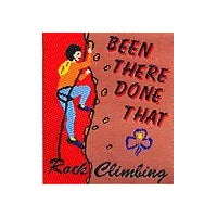 unbound cloth badge showing a girl rock climbing