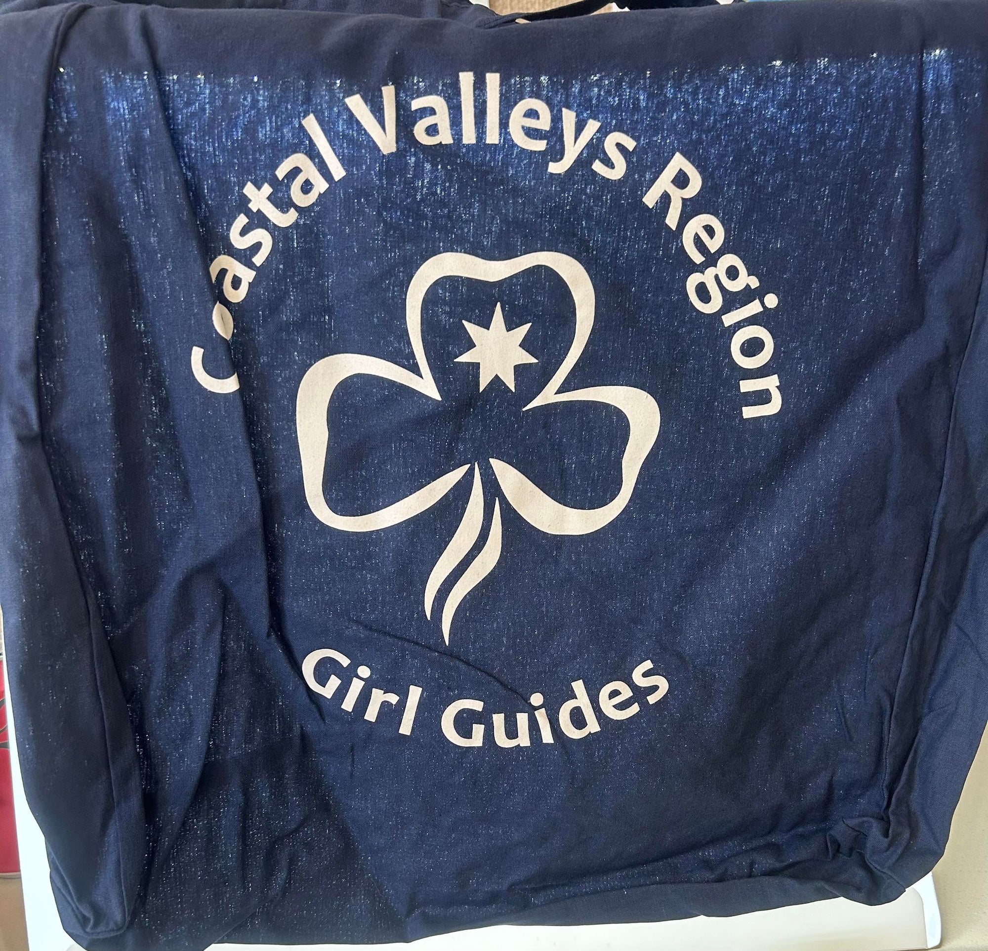 a navy cotton bag with CVR Girl Guides and a trefoil on one side