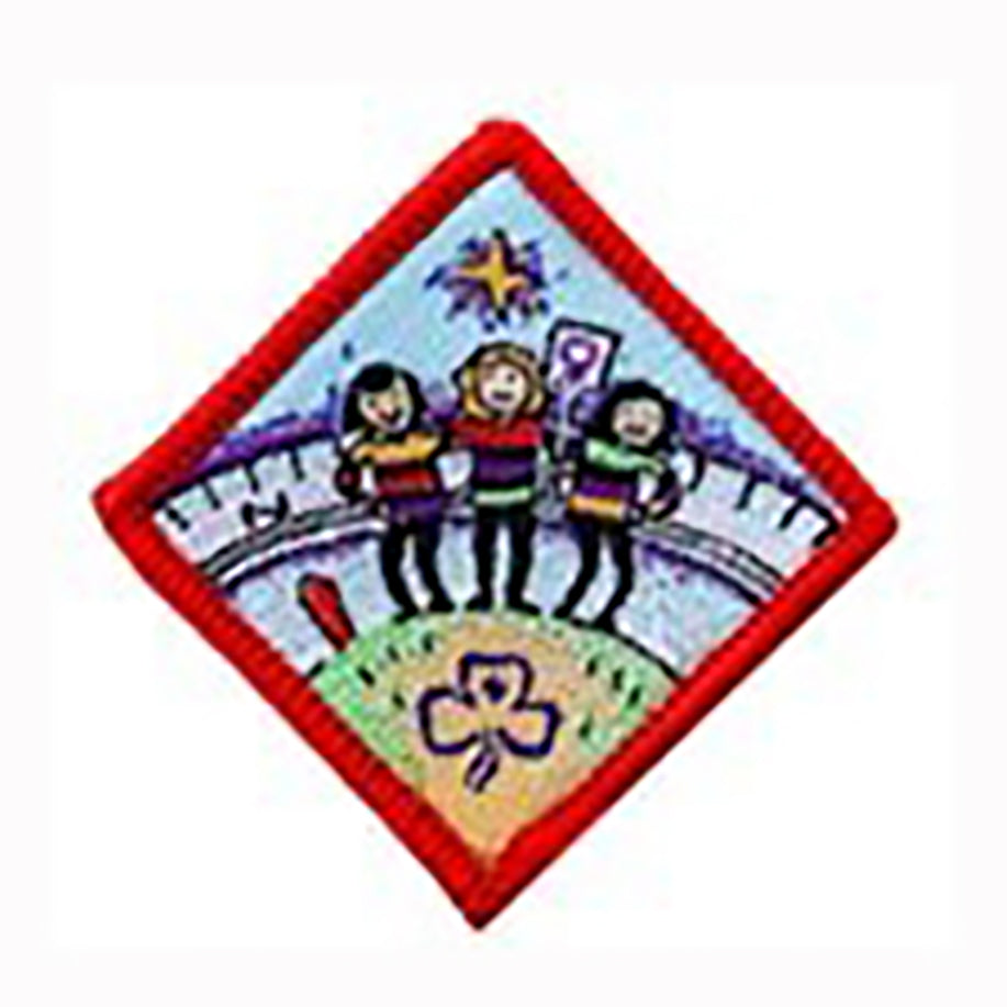 diamond shaped badge bound in red with three girls on the front of it