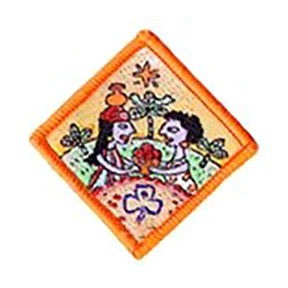 diamond shaped badge bound in orange with two people on it sharing a bowl of flowers in the outdoors