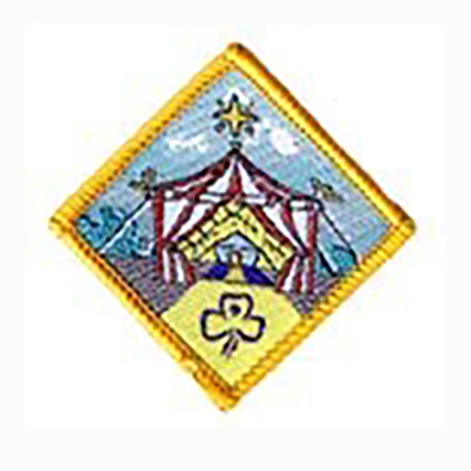 diamond shape badge bound in yellow with a picture of a circus tent on the front
