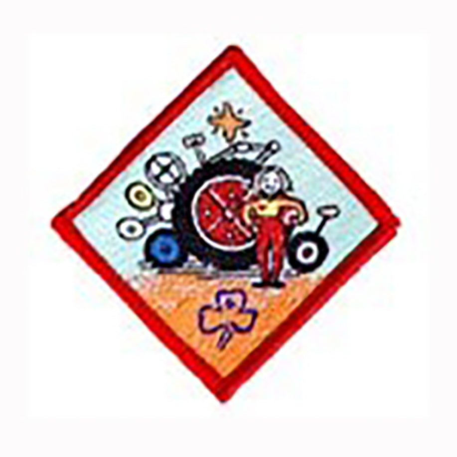 diamond shaped badge bound in red with a girl and a selection of wheels on it