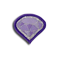 purple badge in the shape of a diamond bound in purple