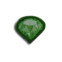 a badge in the shape of a diamond in green bound in green