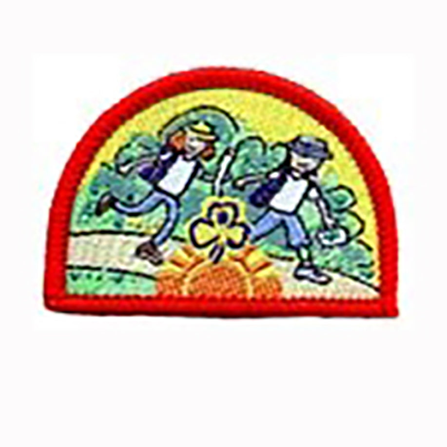 semi circle shaped badge bound in red with two girls walking in the outdoors