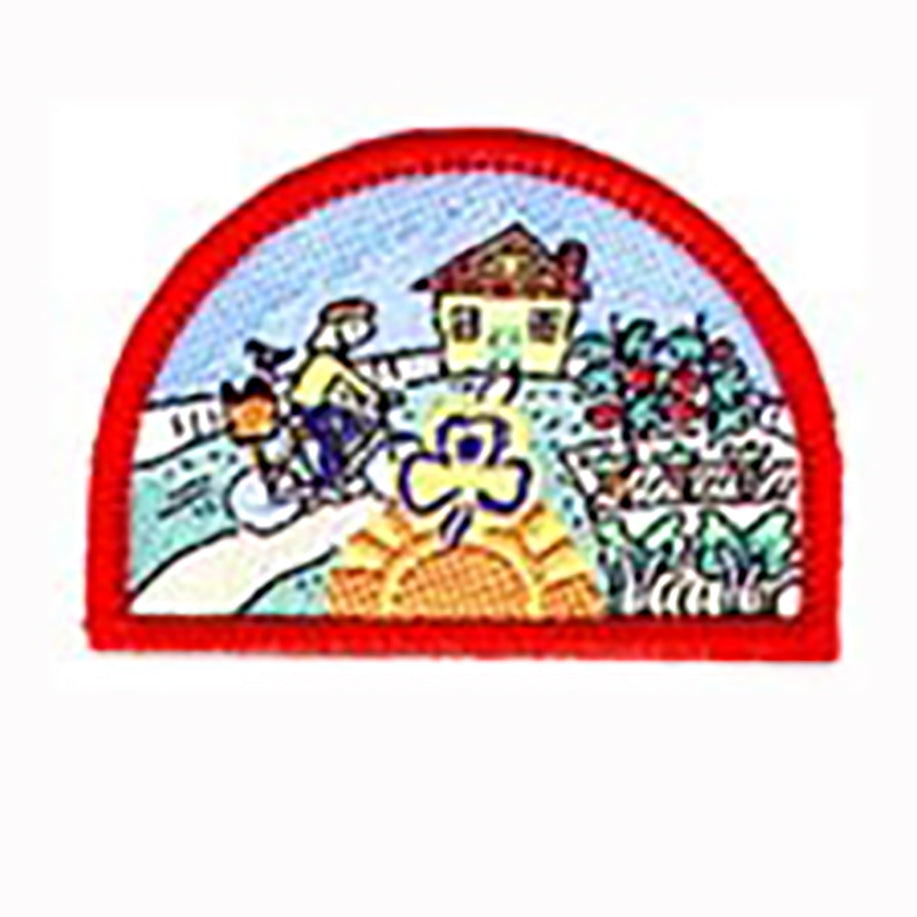 a semi circle shaped badge boudin red with a picture of a house and garden with a girl riding a bike