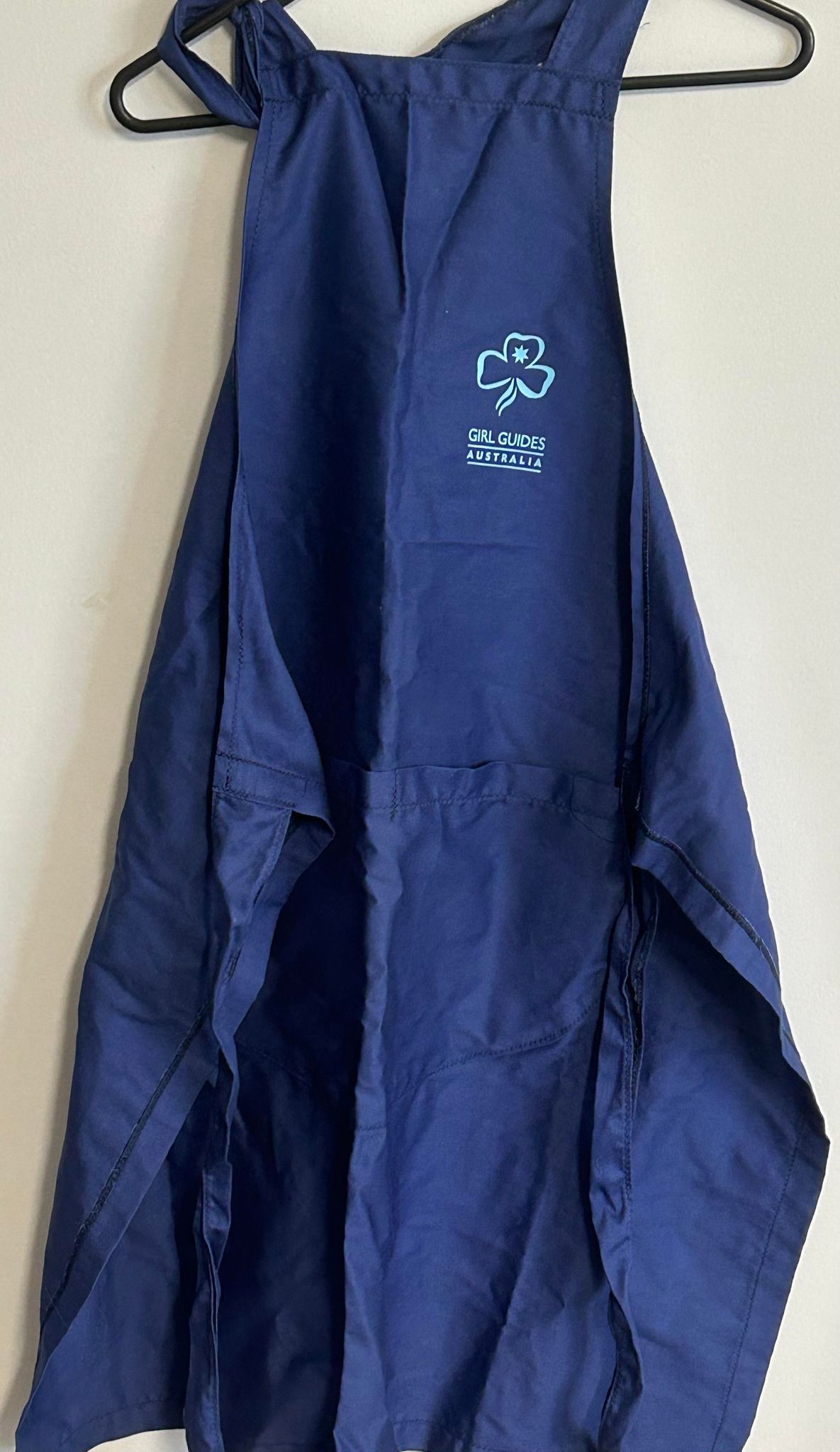a blue apron with the trefoil and girl guides Australia on the top