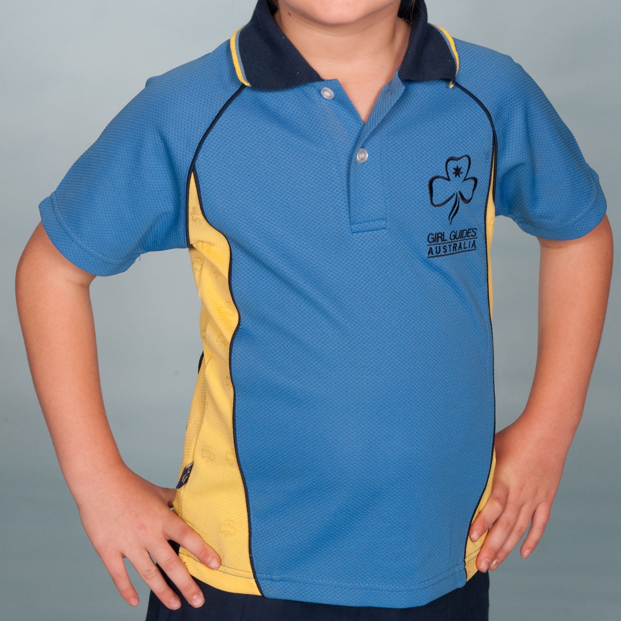 a collared shirt that is sky blue with lemon inserts up the sides with the trefoil and girl guides Australia on the top left