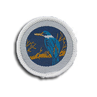 a round badge bound in white with a blue kingfisher bird on it
