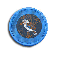a round badge bound in bright blue with a kookaburra on it