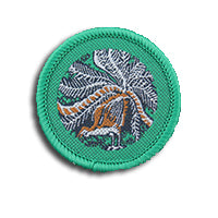 a round badge bound in green with a lyrebird on it