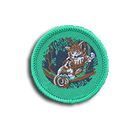 a round badge bound in green with a possum on it