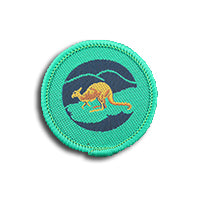 a round badge bound in green with a kangaroo on it