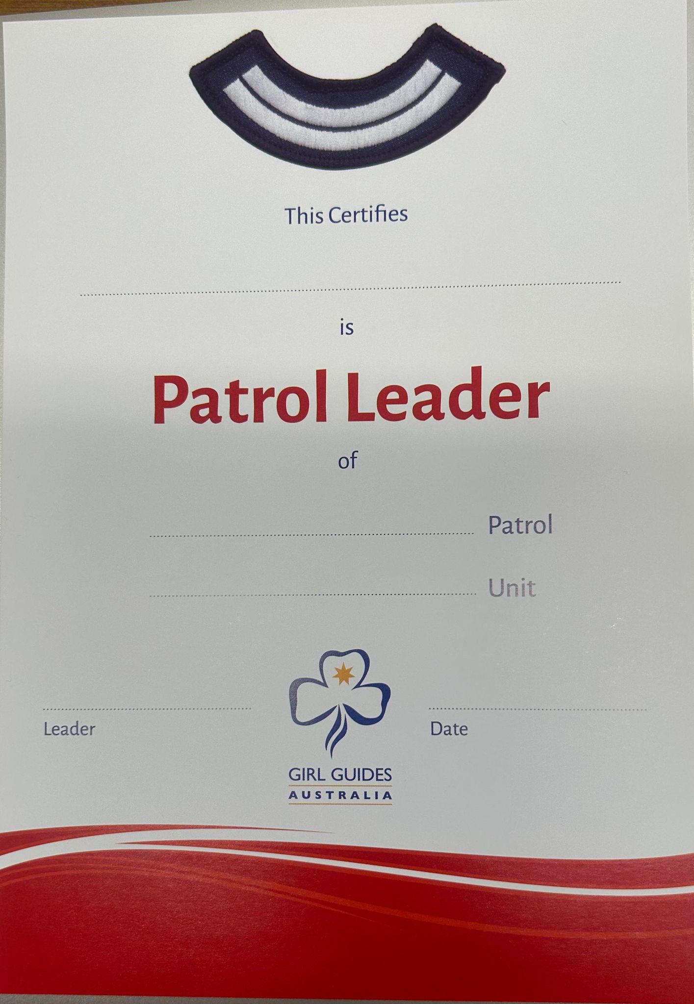 an A5 size certificate with the patrol second stripes and red swirls on it