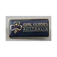 a rectangular blue enamel pin with the words Girl Guides Australia on it that secures the sash while being worn