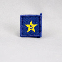 square blue badge with a gold star with the number five in the centre written in blue