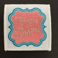 Square bound badge with white background. Gold thank you written on  pink background inside a stylised shape edged in bluea 