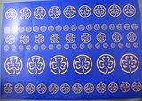 a sheet of gold world badge symbols on a blue background with adhesive backing