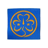Square blue fabric badge with gold world badge woven