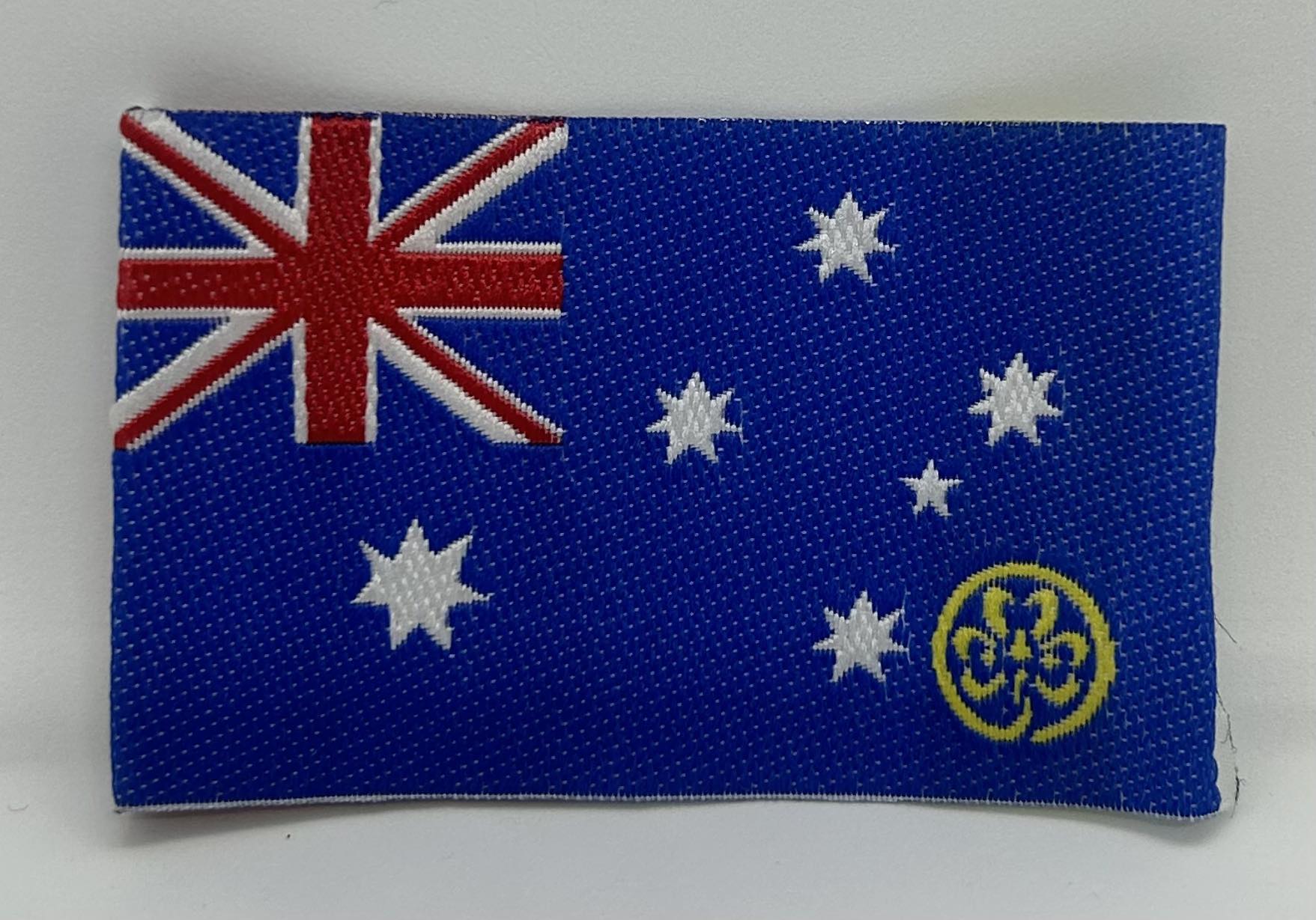 unbound badge of the Australian flag with a gold trefoil in the bottom right