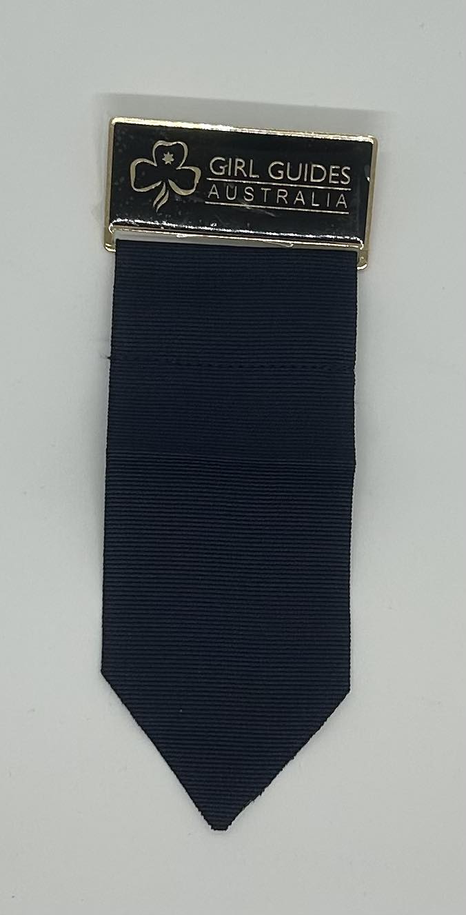 girl guides Australia metal badge with a cloth tab attached for holding metal badges for leaders