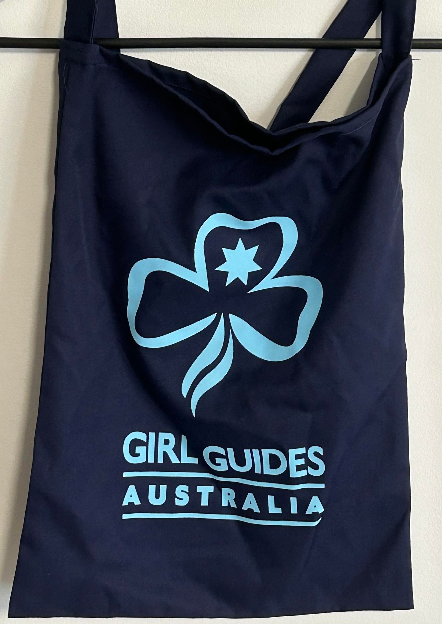 a blue cotton reusable bag with Girl Guides Australia and the Trefoil on one side