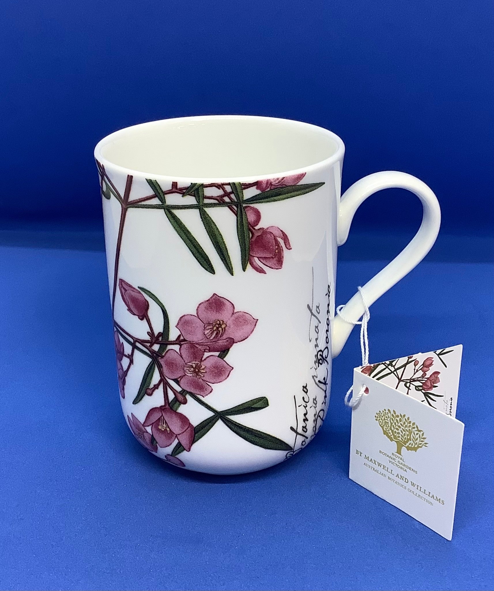 a white coffee cup with pink boronia flowers