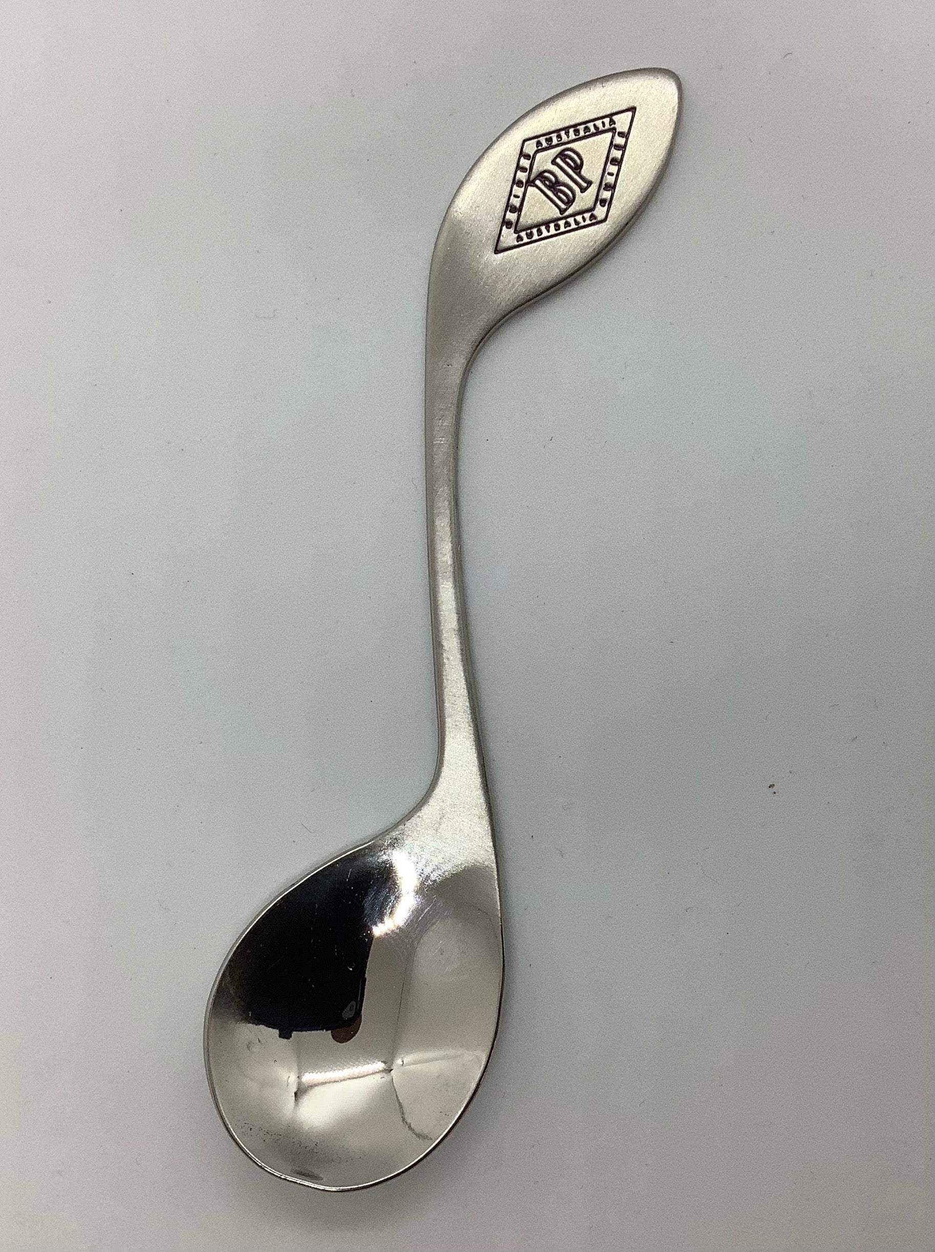 a silver teaspoon with the BP emblem on the top of the handle