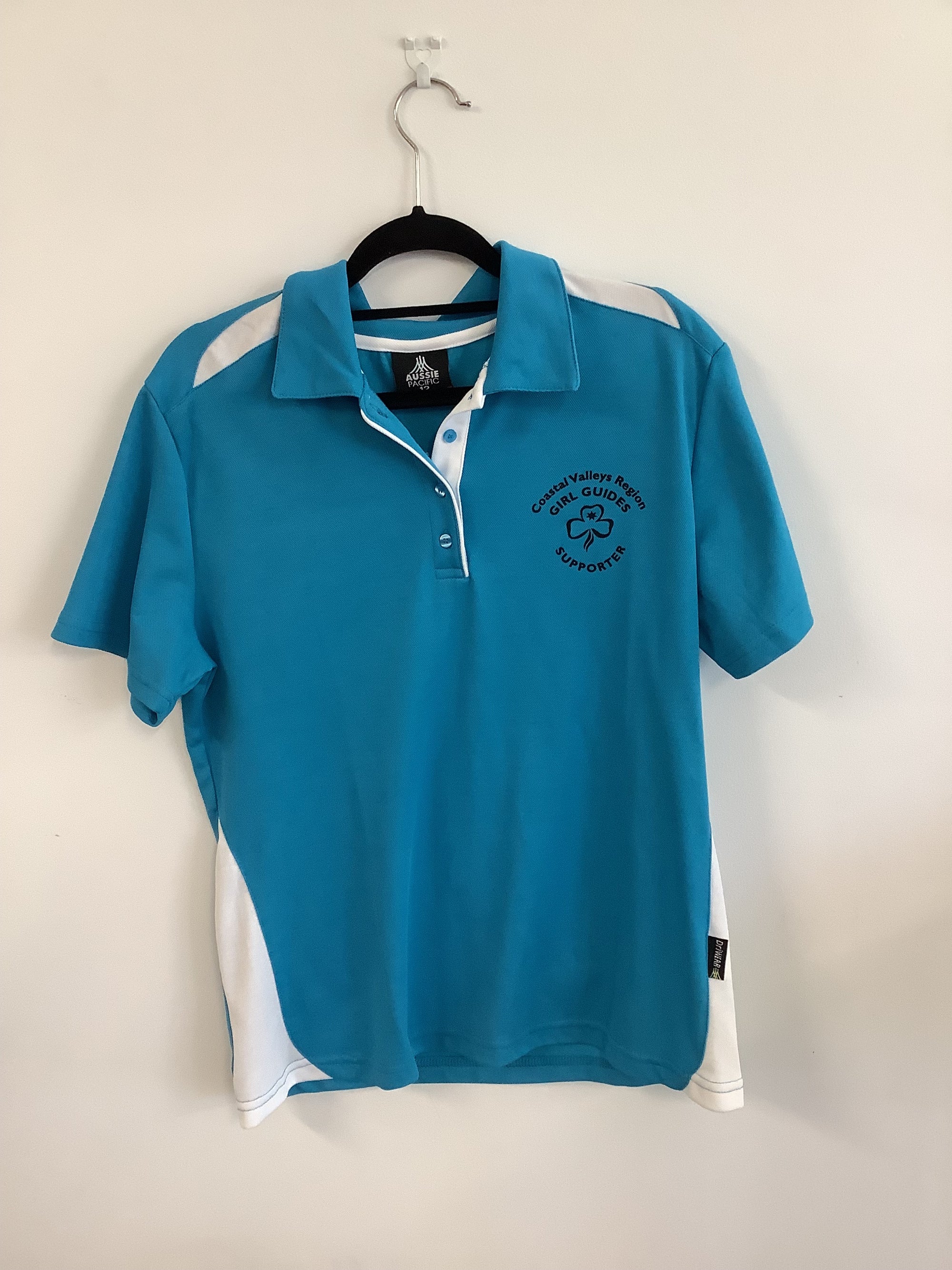 a blue and white polo shirt with a trefoil and CVR girl guides supporter printed on it