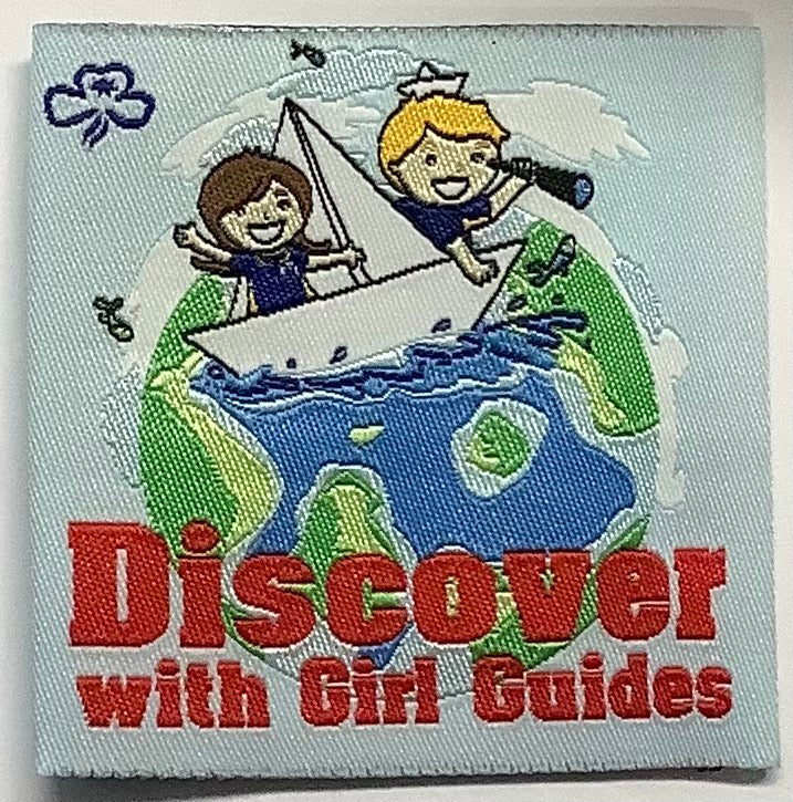 an unbound square badge with a globe and two guides in a sail boat