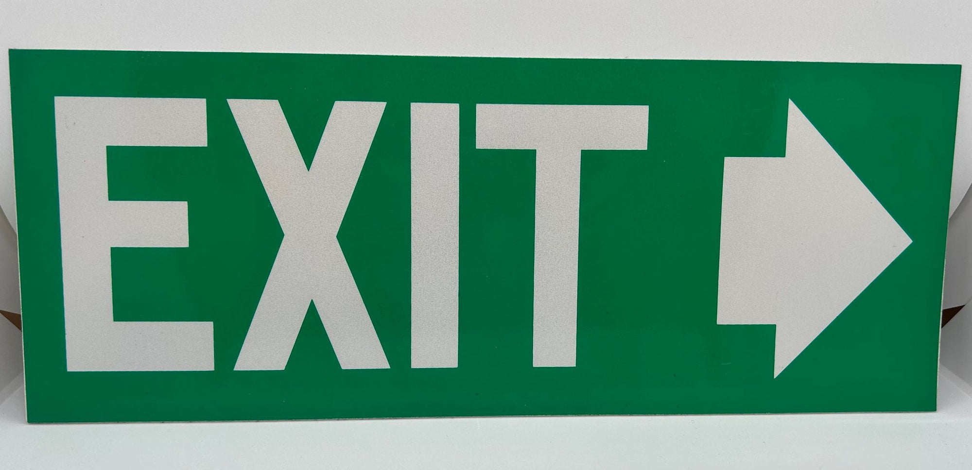 a green rectangle shaped sign with the word exit and an arrow in white