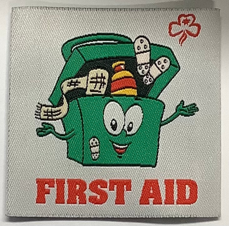 a square unbound badge with a green first aid box with a smiley face and bandaids coming out the top