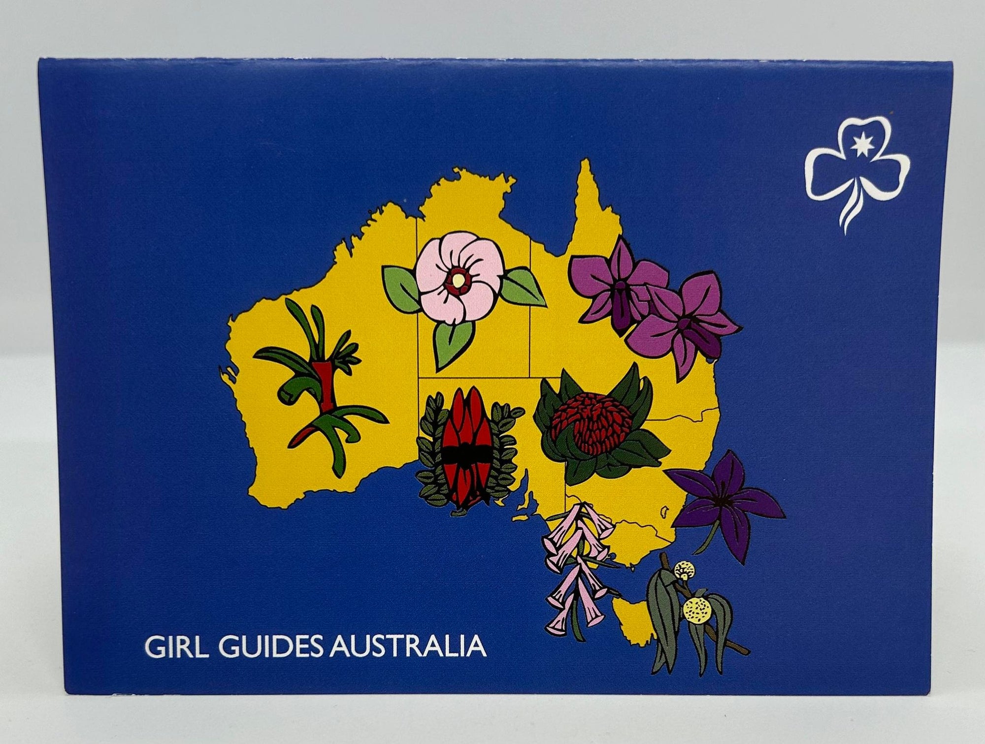 a blank card with a map of Australia on the front with Australian flora as well