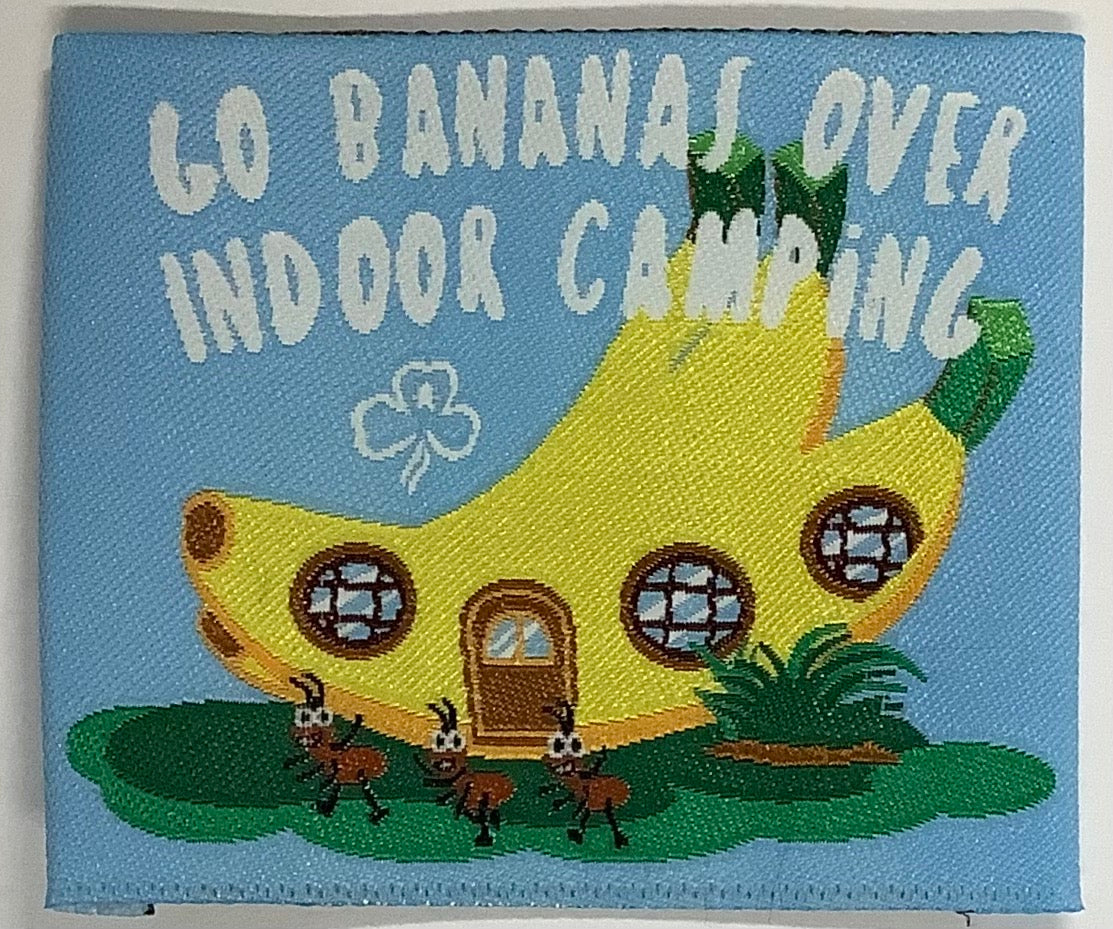 a square unbound badge with a banana shaped hut with ants