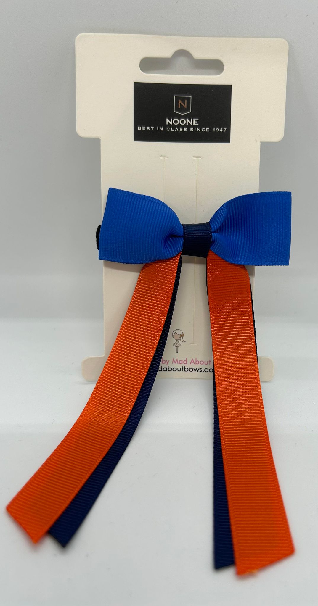 a hair bow in guide colours with long orange tails