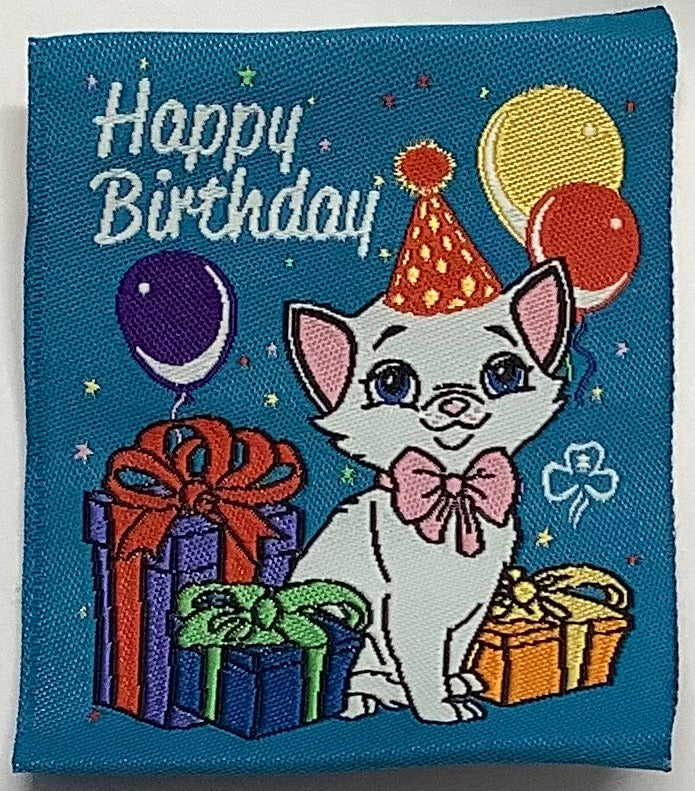 a square blue unbound badge with a cat, presents and balloons