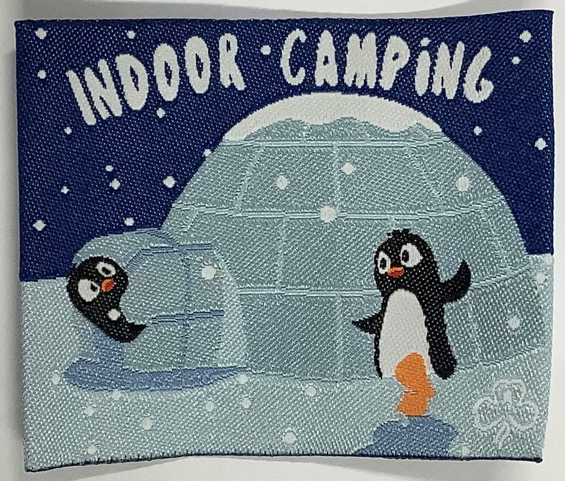 a square unbound badge with an igloo with two penguins