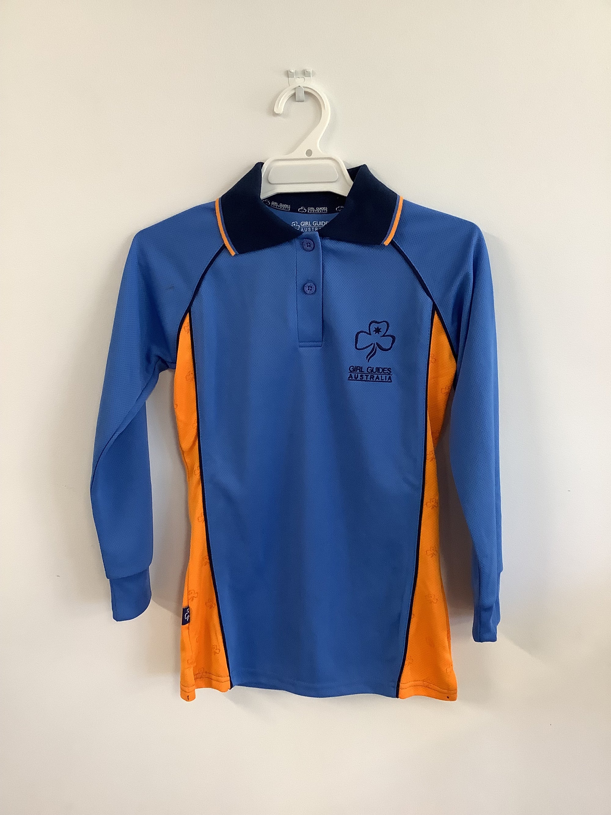 a blue guide polo shirt with long sleeves with the orange inserts in the sides