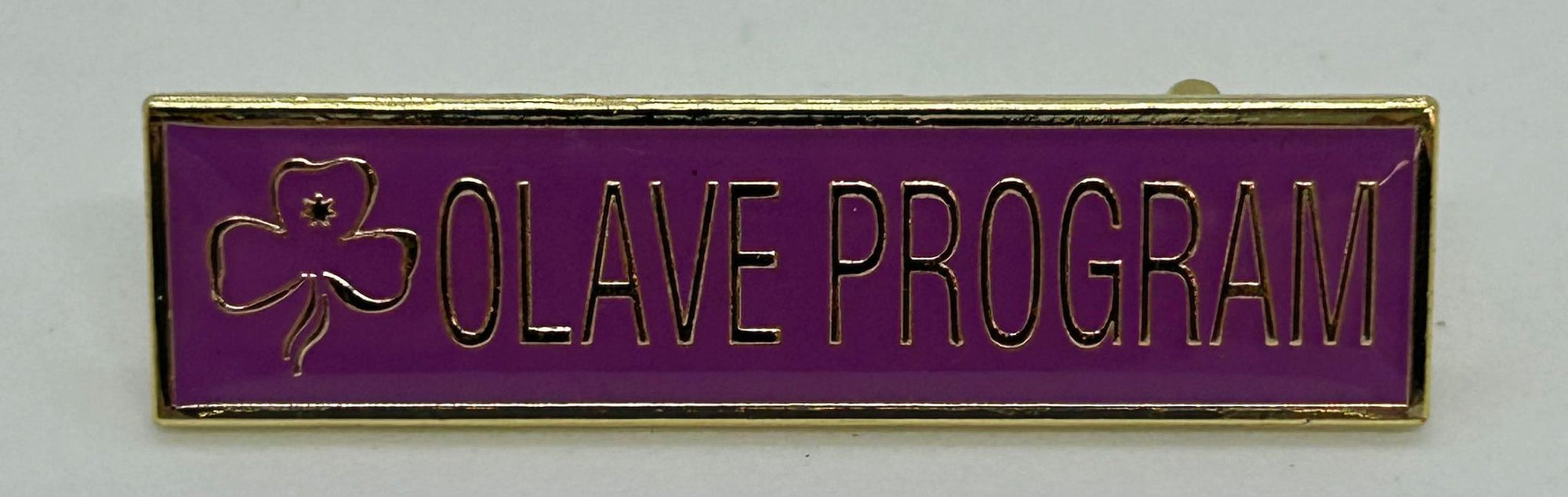 a rectangular metal badge with a purple enamel front with the words olive program written in gold