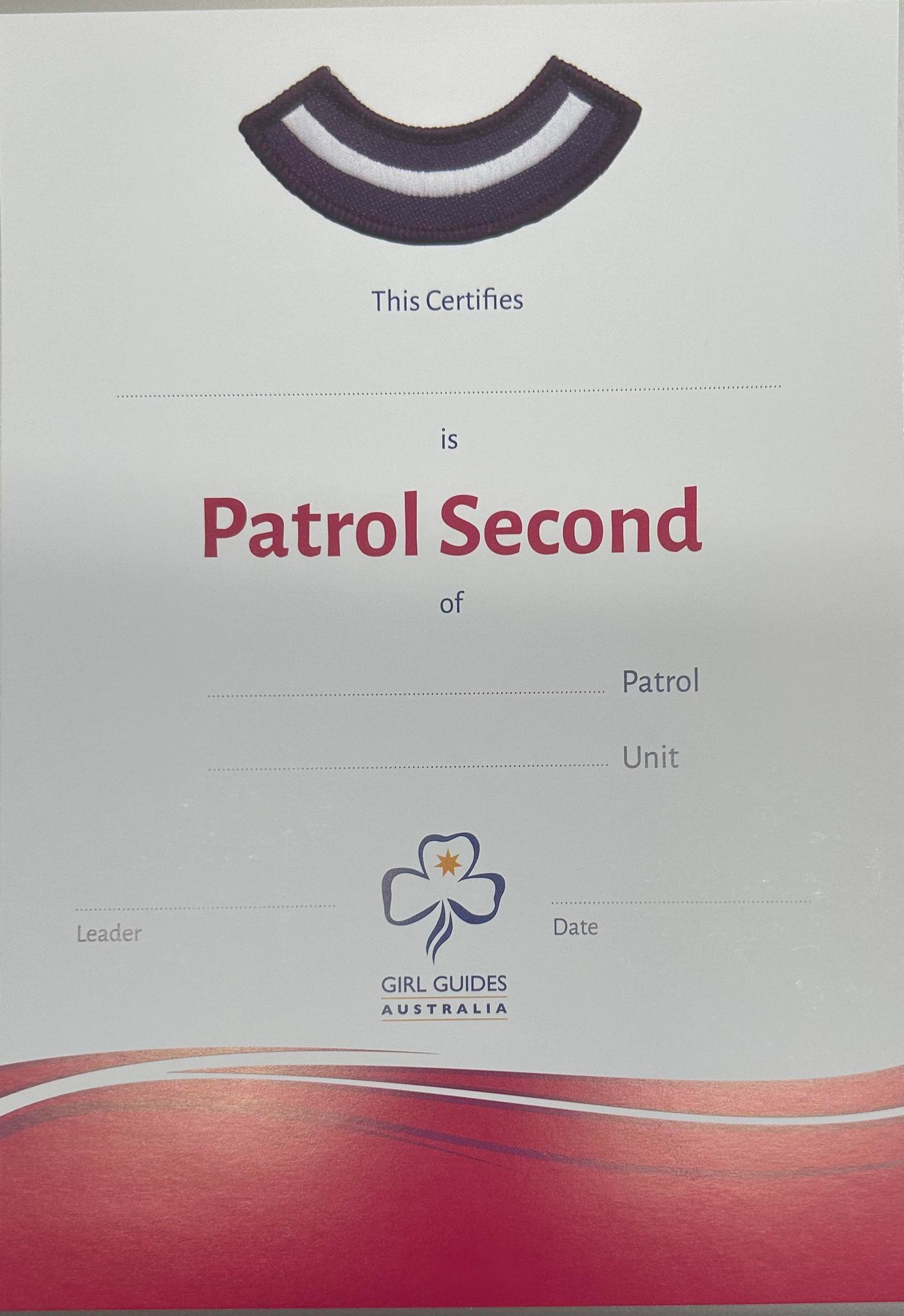 an A5 certificate with patrol second and the stripes on it with red swirls