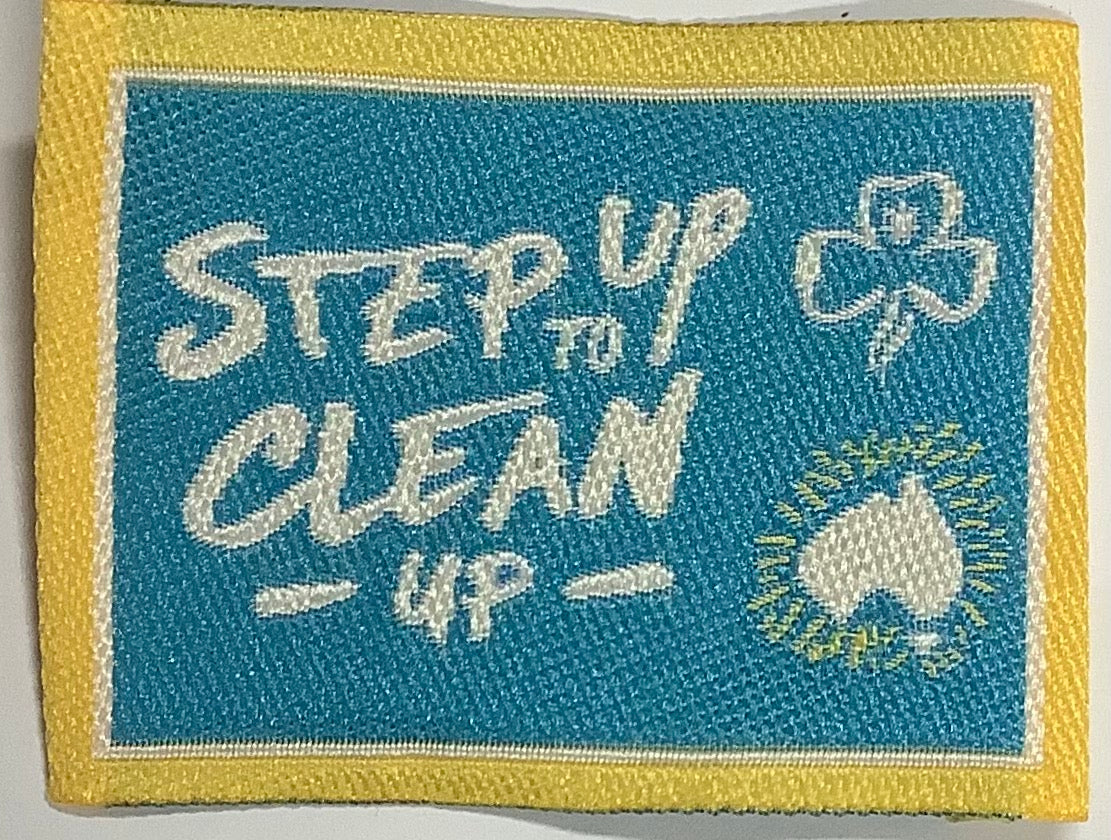 a square unbound badge with a map of Australia and step up tp clean up written on it