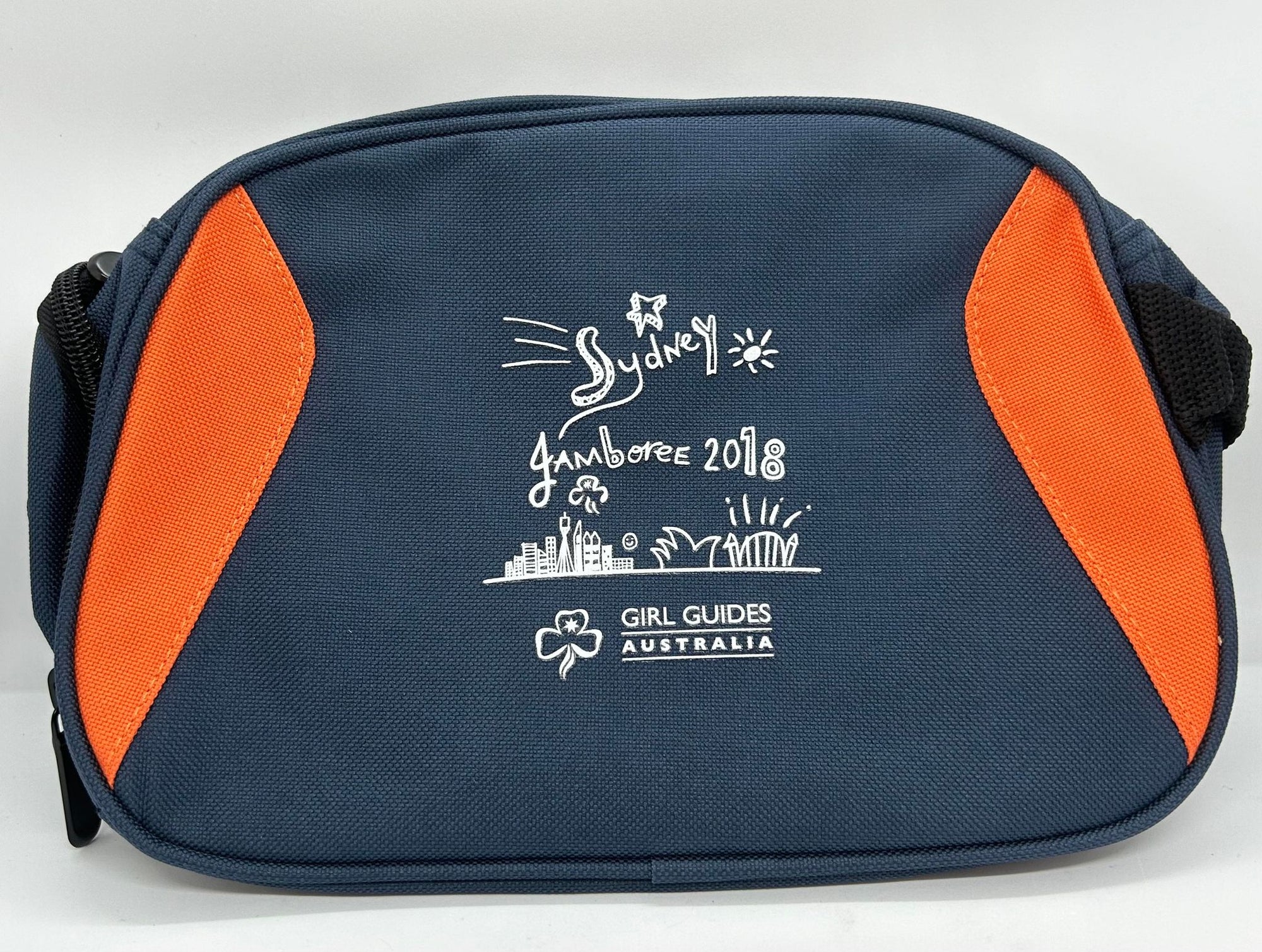 a small navy toiletry bag with the jamboree logo on the front and orange panels down the sides